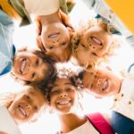 low-angle-view-of-a-group-of-mixed-race-multi-ethnic-classmates-schoolchildren-standing-in-round.jpg