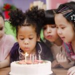 Group of children celebrate birthday's party in classroom.